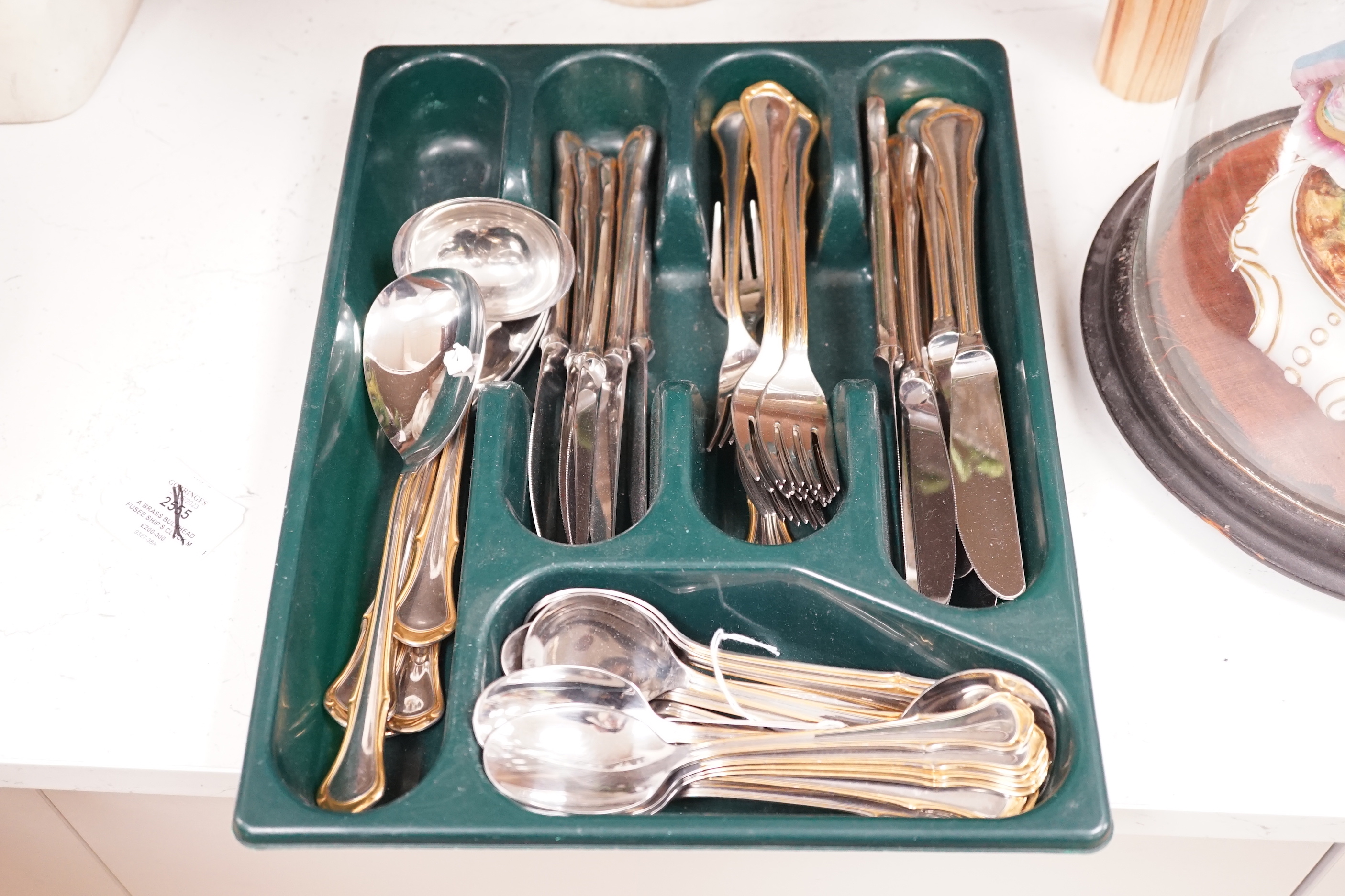 Assorted plated flatware and a pair of plated candlesticks